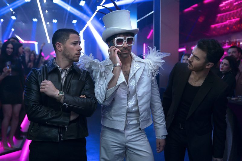 Nick (far left), Joe and Kevin Jonas get a dose of the holiday spirit on a quest to get home in the musical comedy "A Very Jonas Christmas Movie."