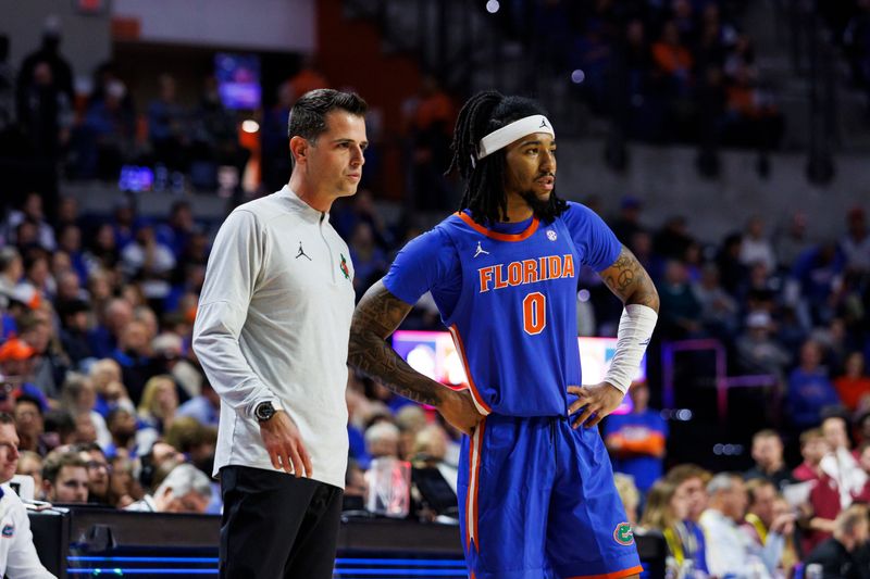 Nov 11, 2025; Gainesville, Florida, USA; Florida Gators head coach Todd Golden and guard Boogie Fland (0) speak during the first half against Florida State Seminoles at Exactech Arena at the Stephen C. O'Connell Center. Mandatory Credit: Morgan Tencza-Imagn Images