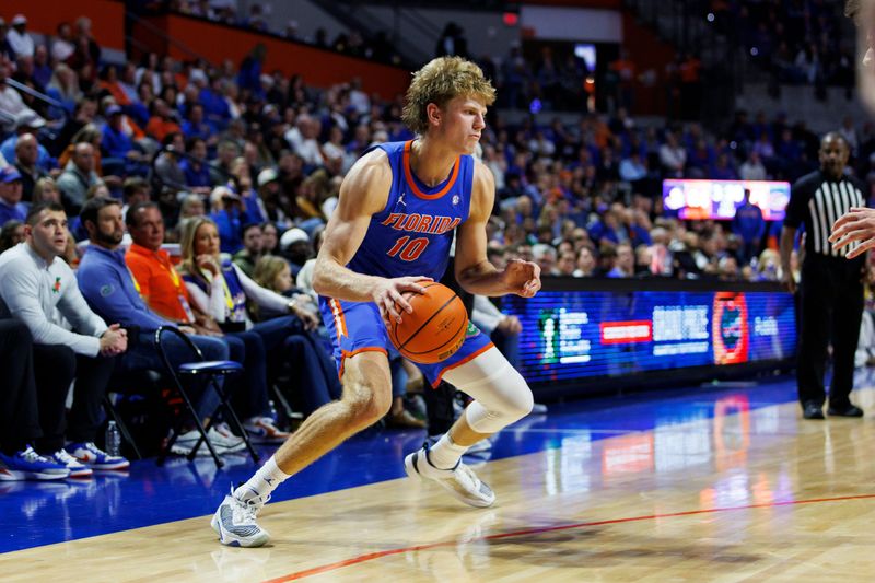 Nov 11, 2025; Gainesville, Florida, USA; Florida Gators forward Thomas Haugh (10) dribbles the ball against the Florida State Seminoles during the second half at Exactech Arena at the Stephen C. O'Connell Center. Mandatory Credit: Morgan Tencza-Imagn Images