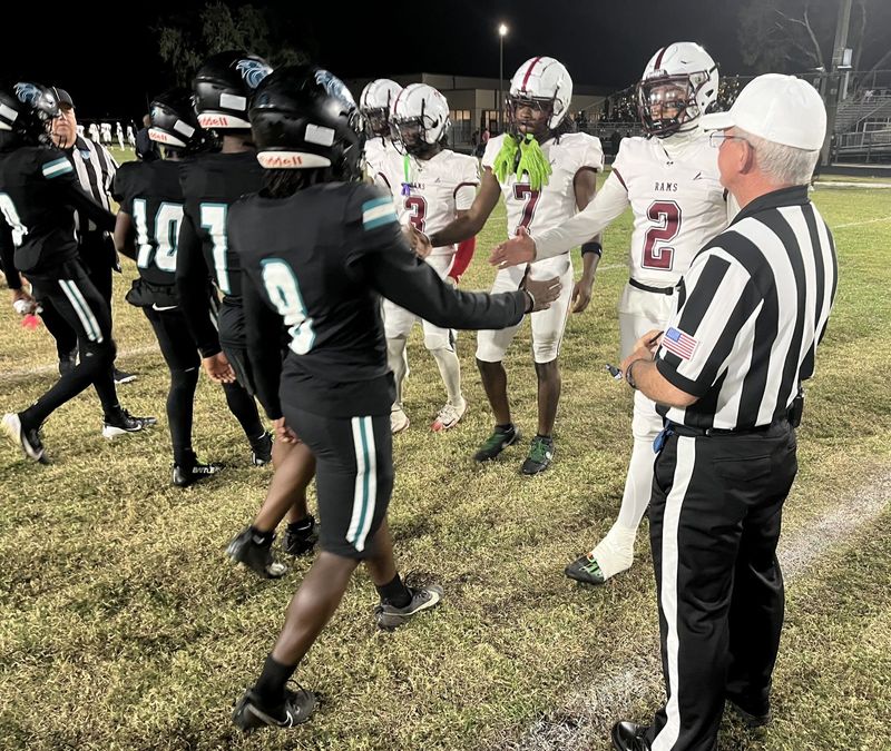 Team captains from Royal Palm Beach and Palm Beach Lakes shake hands at midfield before the coin toss. The teams chose not to shake hands after the game, which turned heated in the fourth quarter.