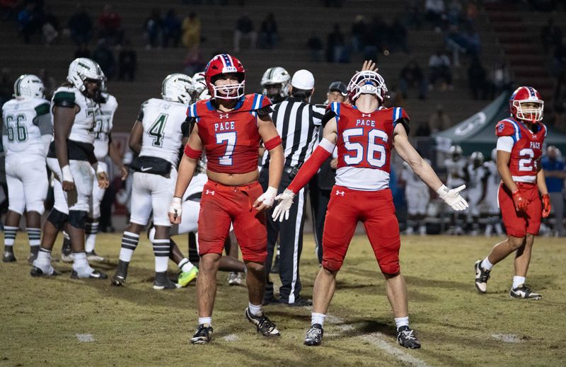Patriots Nathan Wilson (56) celebrates a big defensive play during the Evans vs Pace 6A Regional Quarterfinals football game at Pace High School on Nov. 14, 2025.