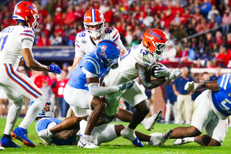 Nov 15, 2025; Oxford, Mississippi, USA; Florida Gators running back Jadan Baugh (13) runs for yards after the catch against Mississippi Rebels safety Wydett Williams Jr. (16) during the second quarter at Vaught-Hemingway Stadium. Mandatory Credit: Petre Thomas-Imagn Images