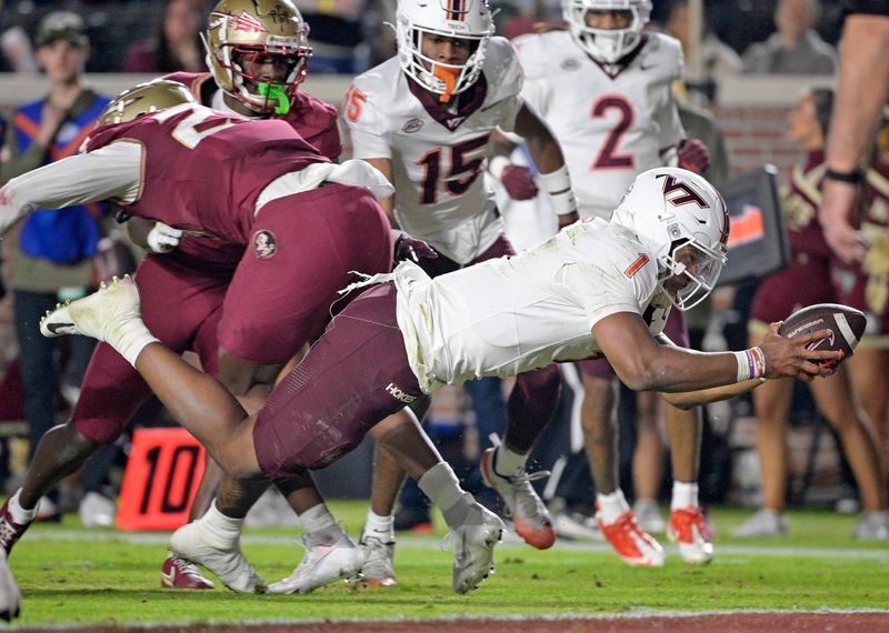 Nov 15, 2025; Tallahassee, Florida, USA; Virginia Tech Hokies quarterback Kyron Drones (1) dives for a touchdown during the first half against the Florida State Seminoles at Doak S. Campbell Stadium. Mandatory Credit: Melina Myers-Imagn Images