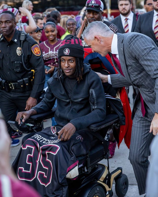Mike Norvell greets Ethan Pritchard Nov. 15 after arriving for the Legacy Walk. Ethan, who was shot in the head during a case of mistaken identity in August, led the team into Doak Cambell Stadium.