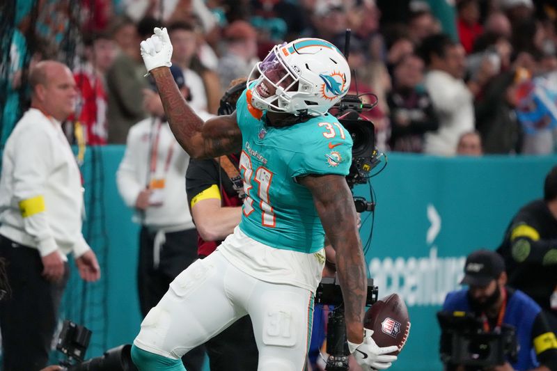 Nov 16, 2025; Madrid, Spain; Miami Dolphins running back Ollie Gordon II (31) celebrates after scoring a touchdown against the Washington Commanders in the fourth quarter during the 2025 NFL Madrid Game at Santiago Bernabeu Stadium. Mandatory Credit: Kirby Lee-Imagn Images