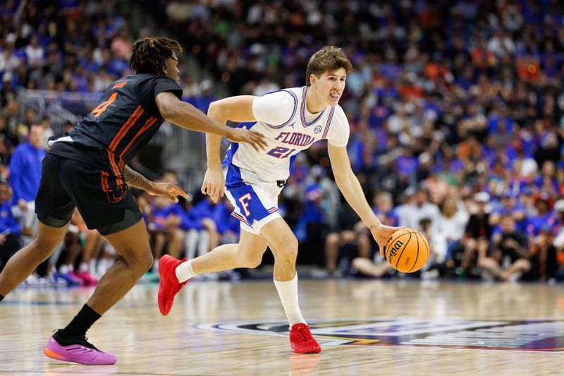 Nov 16, 2025; Jacksonville, Florida, USA; Miami Hurricanes guard Marcus Allen (4) defends Florida Gators forward Alex Condon (21) during the first half at VyStar Veterans Memorial Arena. Mandatory Credit: Matt Pendleton-Imagn Images