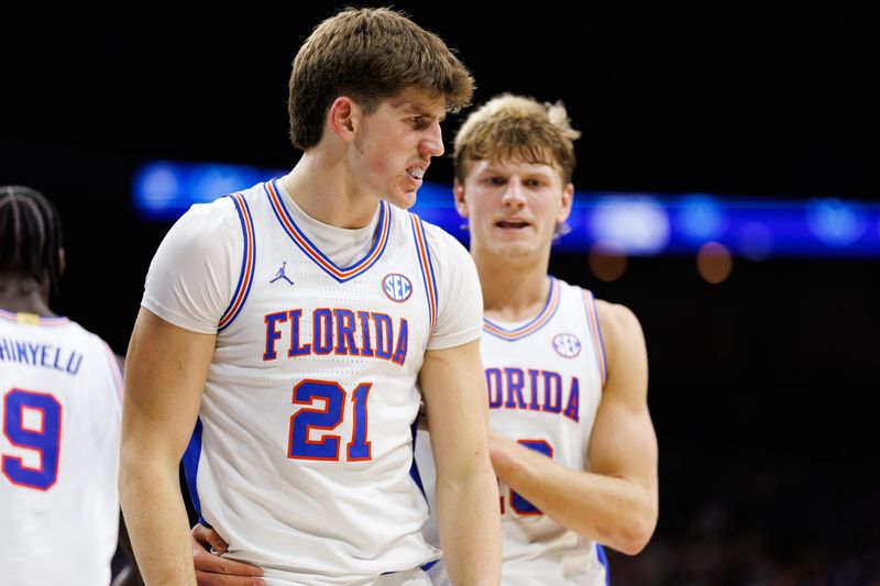 Nov 16, 2025; Jacksonville, Florida, USA; Florida Gators forward Alex Condon (21) reacts after making a basket with Florida Gators forward Thomas Haugh (10) against the Miami Hurricanes during the first half at VyStar Veterans Memorial Arena. Mandatory Credit: Matt Pendleton-Imagn Images