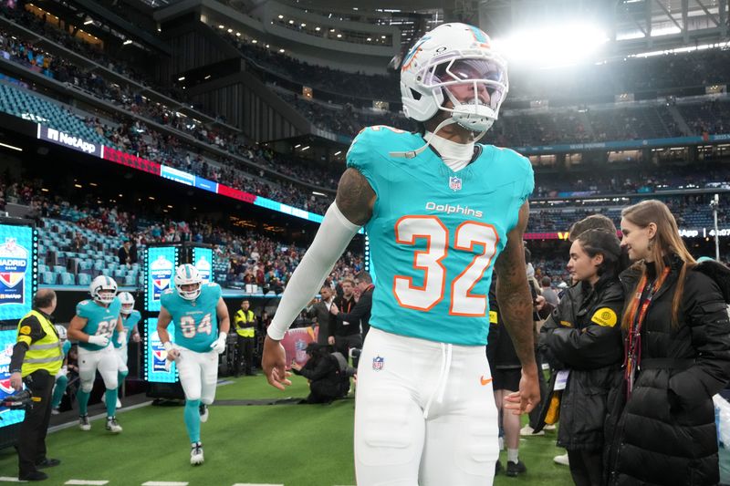 Nov 16, 2025; Madrid, Spain; Miami Dolphins cornerback JuJu Brents (32) runs onto the field prior to the 2025 NFL Madrid Game against the Washington Commanders at Santiago Bernabeu Stadium. Mandatory Credit: Kirby Lee-Imagn Images