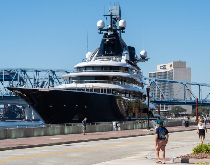Pedestrians admire Jacksonville Jaguars owner Shad Khan's mega yacht, Kismet, as it was docked on the St. Johns River near the Hyatt Regency Jacksonville Riverfront and the Main Street Bridge on Monday, Nov. 17, 2025, in Jacksonville, Fla. [Doug Engle/Florida Times-Union]