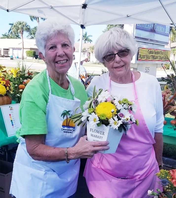 Marianne Foley and Connie Lowery sell floral designs at a previous Plant and Floral Design Sale.