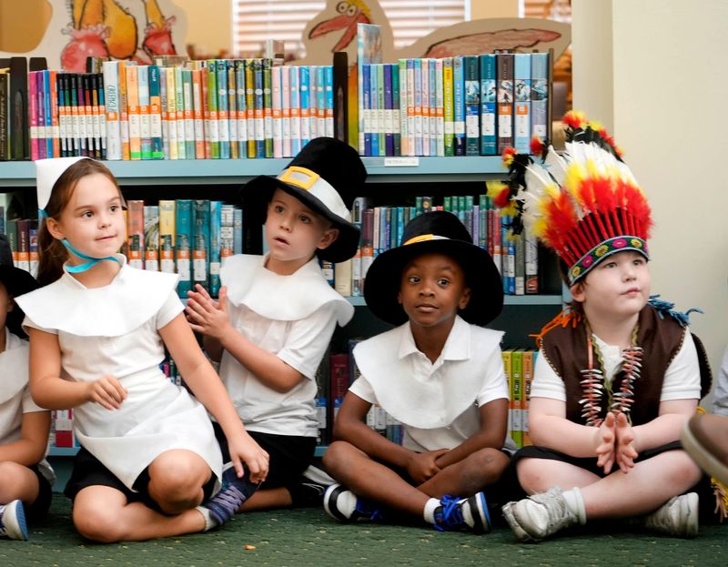 Kate Worster, 6, from left, Ryan O’Donnell, 5, Khyree Grant, 5, and Alexander Maass, 5, participate in the Palm Beach Public Elementary kindergarten Thanksgiving celebration at the Society of the Four Arts Children’s Library on Nov. 18.