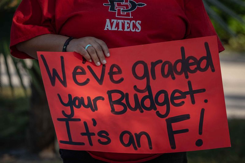 School District of Palm Beach County teachers and supporters waved signs and chanted for higher wages before the school board meeting outside the district's headquarters on Forest Hill Boulevard in Palm Springs, Fla., on November 19, 2025.