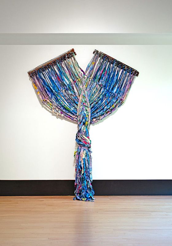 KX2’s sculptural work includes this piece, “Aurae,” seeking to merge repurposed metals and recycled canvas to explore the tension between beauty and environmental strain.