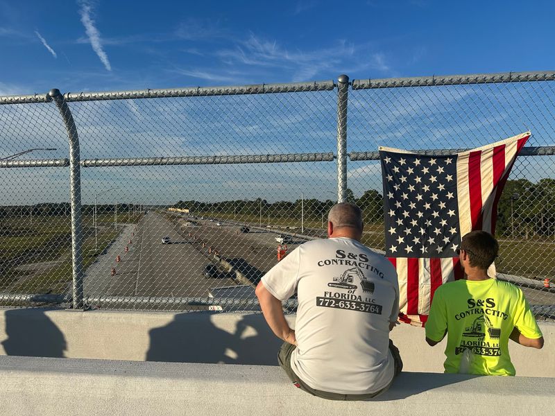 A handful of people, including IRCSO and IRCFR officials, waited on the Oslo Road overpass of Interstate 95 for the procession to pass.