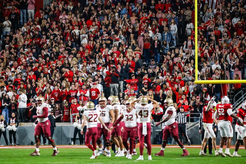 Nov 21, 2025; Raleigh, North Carolina, USA; Florida State Seminoles kicker Jake Weinberg (22) attempts a field goal but misses while NC State Wolfpack fans react during the first half of the game at Carter-Finley Stadium. Mandatory Credit: Jaylynn Nash-Imagn Images