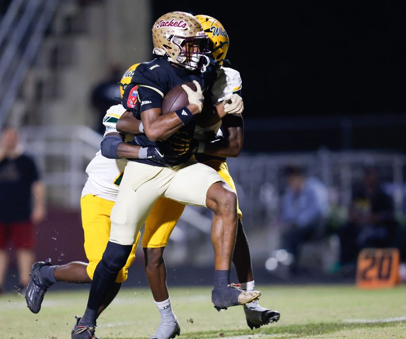 St. Augustine Yellow Jackets receiver Somourian Wingo (1) breaks tackles while on his way to the first score of the game against Ed White.