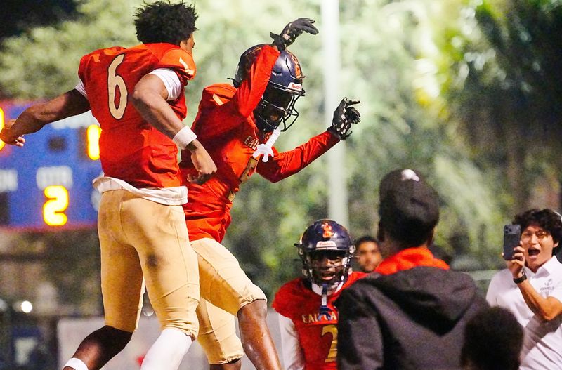 Captain Rolle of Eau Gallie clebrates a touchdown against Merritt Island with teammate X’Zavier Corbin in the Class 3A football regional semifinal November 21, 2025. Craig Bailey, FLORIDA TODAY via USA TODAY NETWORK