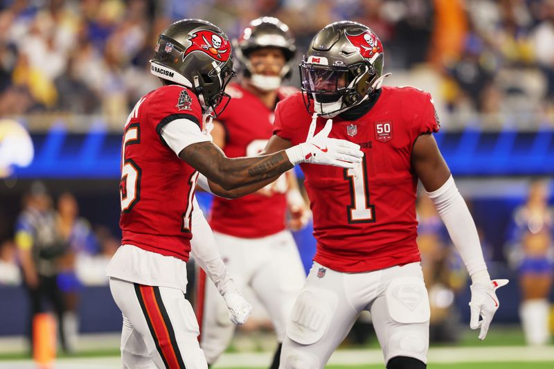 Nov 23, 2025; Inglewood, California, USA; Tampa Bay Buccaneers wide receiver Tez Johnson (15) celebrates with running back Rachaad White (1) after scoring a touchdown against the Los Angeles Rams during the second quarter at SoFi Stadium.