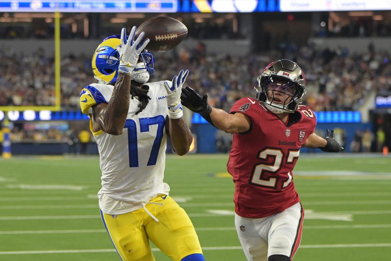Nov 23, 2025; Inglewood, California, USA; Los Angeles Rams wide receiver Davante Adams (17) catches a one-yard touchdown pass thrown by quarterback Matthew Stafford (not pictured) against Tampa Bay Buccaneers cornerback Zyon McCollum (27) during the first quarter at SoFi Stadium. Mandatory Credit: Jayne Kamin-Oncea-Imagn Images