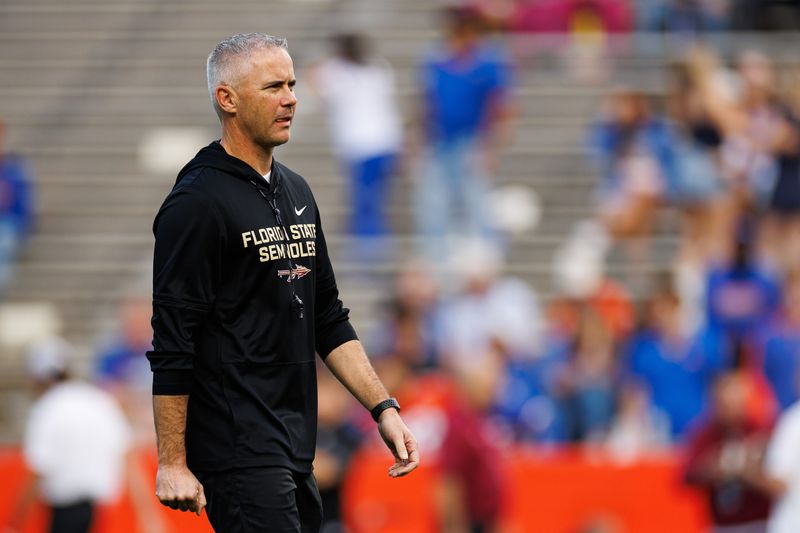 Nov 29, 2025; Gainesville, Florida, USA; Florida State Seminoles head coach Mike Norvell walks on the field before a game against the Florida Gators at Ben Hill Griffin Stadium. Mandatory Credit: Matt Pendleton-Imagn Images
