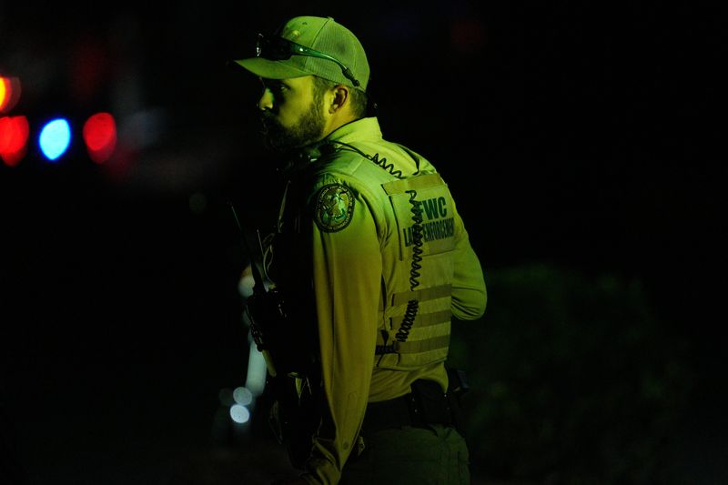 A large amount of emergency officials and law enforcement are gathered at the Cape Coral Yacht Club investigating a boat crash in the Caloosahatchee River on Saturday, Nov. 29, 2025.