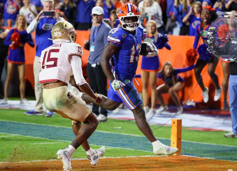 Florida running back Jadan Baugh (13) scores during the second half of an NCAA football game at Steve Spurrier Field at Ben Hill Griffin Stadium in Gainesville, FL on Saturday, November 29, Florida beat Florida State 40-21.2025. [Alan Youngblood/Gainesville Sun]