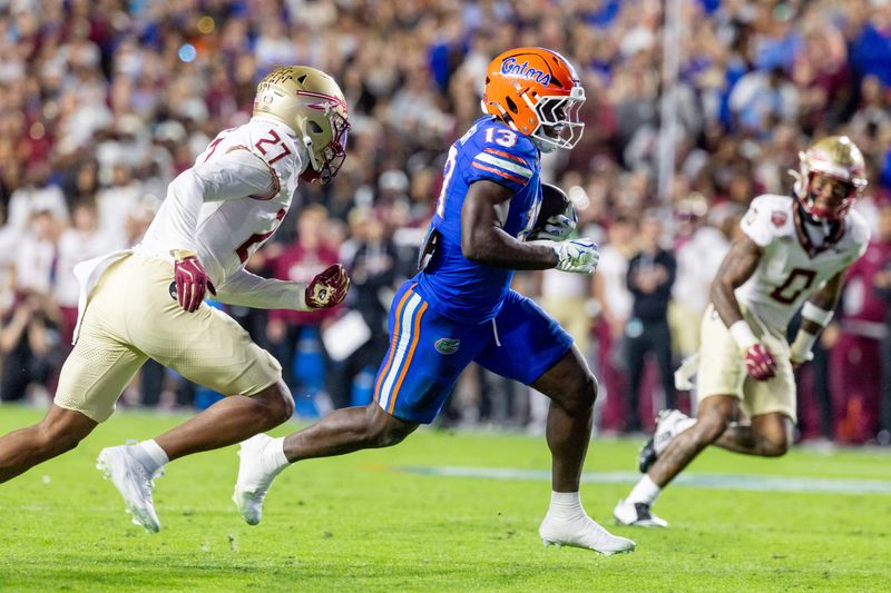 Nov 29, 2025; Gainesville, Florida, USA; Florida Gators running back Jadan Baugh (13) runs with the ball during the third quarter against the Florida State Seminoles at Ben Hill Griffin Stadium. Mandatory Credit: Bob Kupbens-Imagn Images