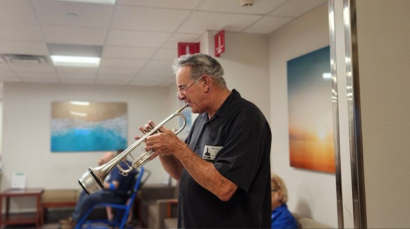 Professional trumpeter Jeff Kaye, pictured here performing in a Boca Raton Regional Hospital public corridor, founded Healing Arts Project with his wife Joanna Marie Kaye in order to the relieve stress on staffers and to promote healing among patients.