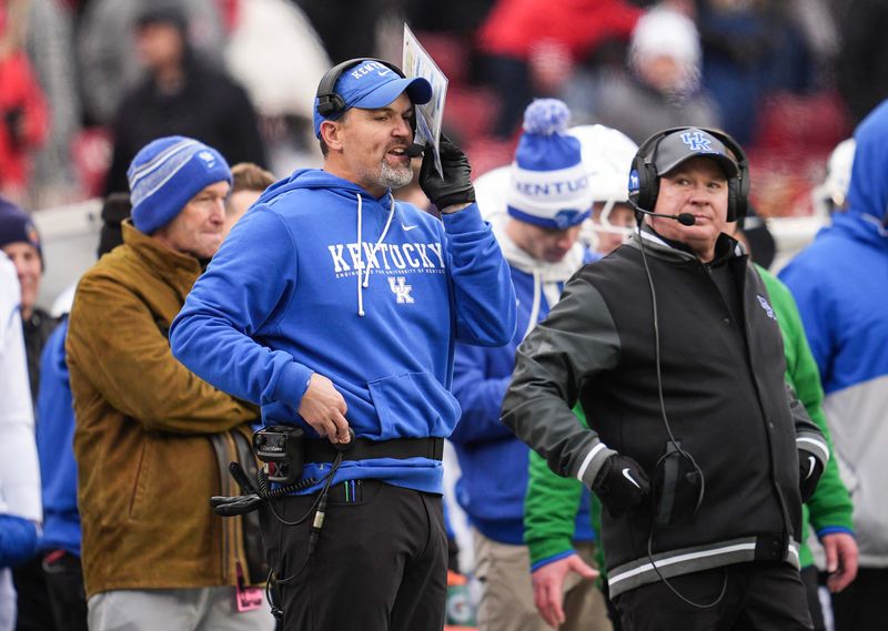 Kentucky defensive coordinator Brad White and head football coach Mark Stoops on the sidelines as UK athletic director Mitch Barnhart stands behind them at left during the loss against UofL Saturday, November 29, 2025 in Louisville, Kentucky at L&N Federal Credit Union Stadium. The Cards shut out the Cats 41-0.