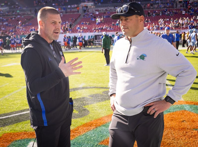Florida Gators head coach Billy Napier and Tulane Green Wave head coach John Sumrall talk before the start of the game during warmups at Raymond James Stadium in Tampa, FL on Friday, December 20, 2024 in the 2024 Union Home Mortgage Gasparilla Bowl. [Doug Engle/Gainesville Sun]