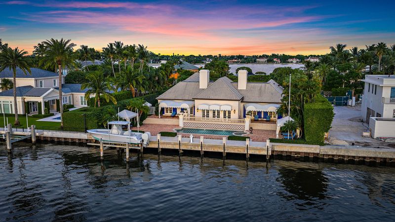 A view to the east at sunrise shows the house at 751 Island Drive on Palm Beach's Everglades Island. With 100 feet of frontage on the Intracoastal Waterway, the house has changed for a recorded $30 million.