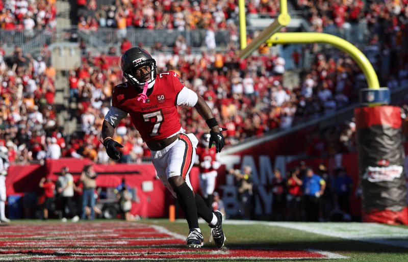 Nov 30, 2025; Tampa, Florida, USA; Tampa Bay Buccaneers running back Bucky Irving (7) celebrates after a touchdown during the second half against the Arizona Cardinals at Raymond James Stadium. Mandatory Credit: Nathan Ray Seebeck-Imagn Images