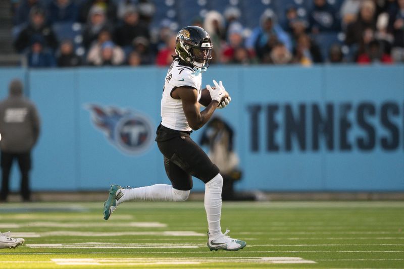 Nov 30, 2025; Nashville, Tennessee, USA; Jacksonville Jaguars wide receiver Brian Thomas Jr. (7) makes a catch against the Tennessee Titans during the second half at Nissan Stadium. Mandatory Credit: Steve Roberts-Imagn Images
