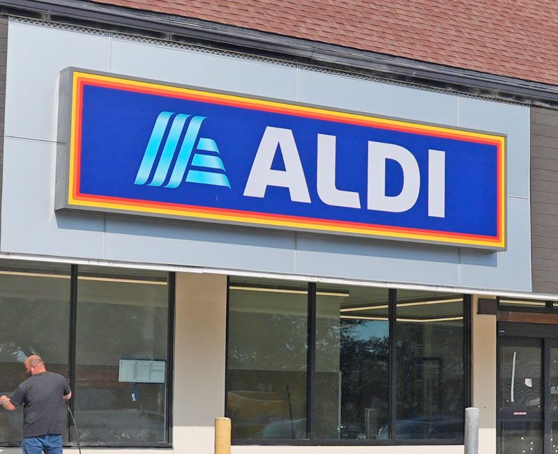 A construction worker puts finishing touches on the exterior of the new Aldi grocery store, where Winn-Dixie used to be, at 4025 S. Nova Road in Port Orange on Thursday, Dec. 4, 2025. The store is set to open Thursday, Dec. 18, following a ribbon-cutting at 8:45 a.m.