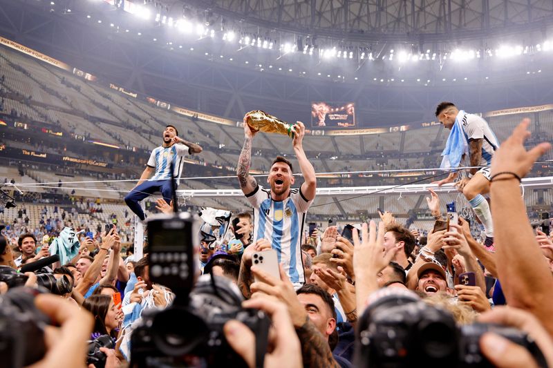 Argentina forward Lionel Messi (10) celebrates with fans after winning the 2022 World Cup final against France at Lusail Stadium in Qatar.