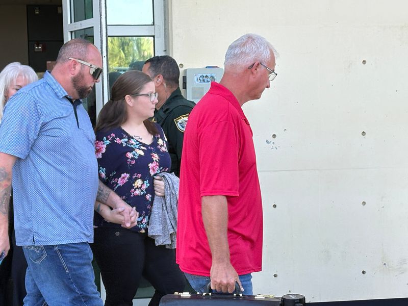 Shauntel Kepner, center, with her husband Chris, as a they leave the Moore Justice Center courthouse in Viera.