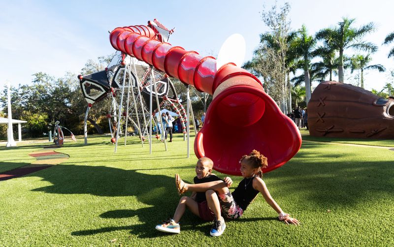 Bella Gavin, and her brother, Stanley, III, play on new playground equipment at the newly re-opened Roberto Clemente Park in Fort Myers on Friday, Dec. 5, 2025. A new 21-foot playground slide was unveiled as the tallest slide in Southwest Florida. Funding sources for the park upgrades included $1,375,000 in city capital improvement funds and a $1 million state grant with the support of Rep. Jenna Persons-Mulicka.