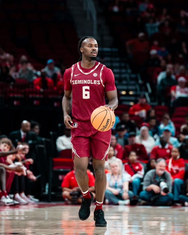 FSU men's basketball guard Robert McCray V dribbles the ball against No. 8 Houston on Saturday, Dec. 6, 2025 at the Toyota Center in Houston, Texas