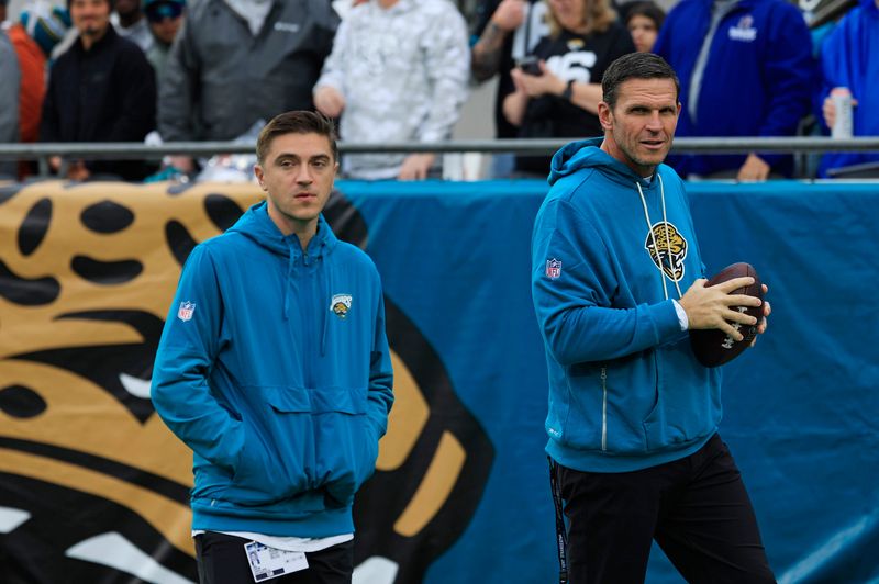 Jacksonville Jaguars general manager James Gladstone, left, and Executive Vice President of Football Operations Tony Boselli walk on the field before an NFL football game at EverBank Stadium, Sunday, Dec. 7, 2025, in Jacksonville, Fla. [Corey Perrine/Florida Times-Union]