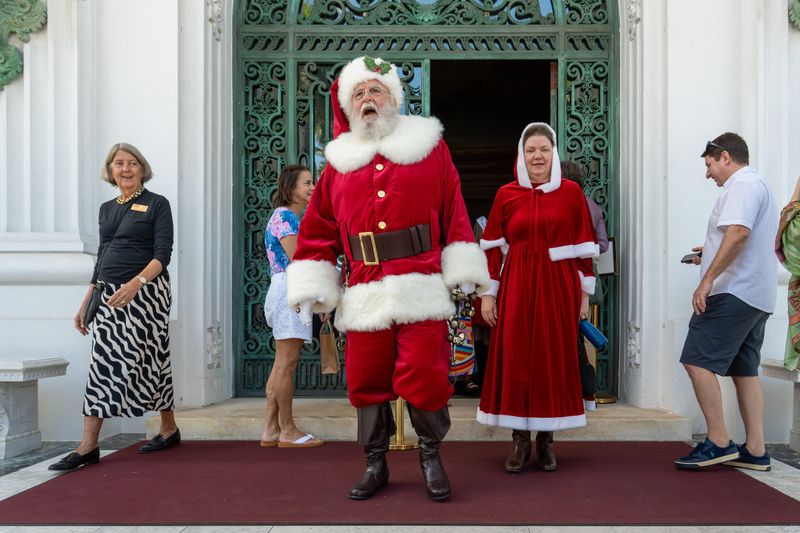 Mr. And Mrs. Claus greet visitors in front of the Flagler Museum during the annual Christmas at Whitehall event Dec. 7 in Palm Beach.