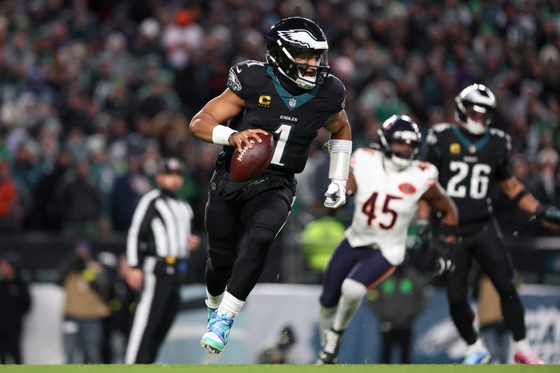 Philadelphia Eagles quarterback Jalen Hurts (1) scrambles with the ball against the Chicago Bears during the third quarter of the game at Lincoln Financial Field in Philadelphia on Nov. 28, 2025.