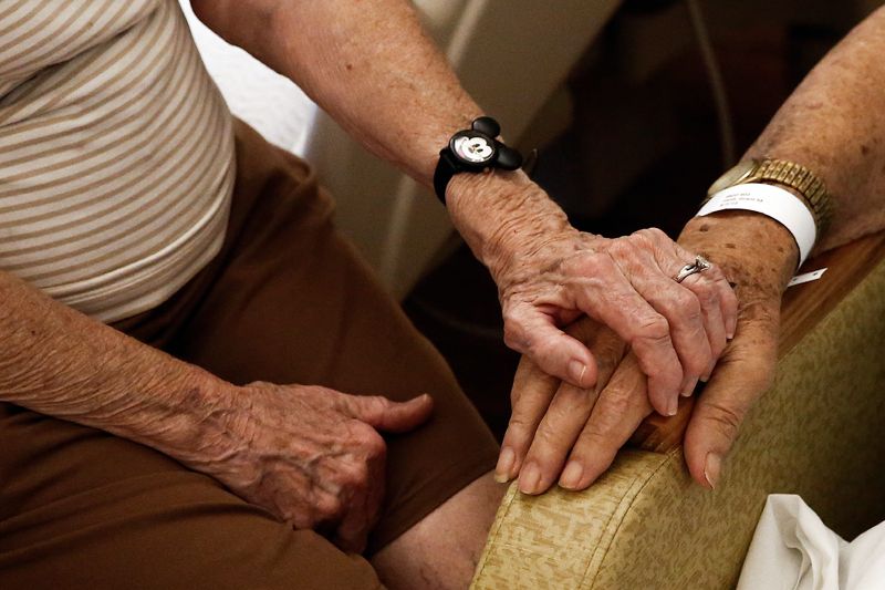 A caregiver visits with a loved one at Avow Hospice in Naples