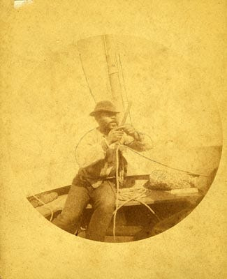 Hawk Massalina, a resident and founder of the former Redfish Point community, works on the rigging of his sailboat. From the G. M. West Photograph Collection housed at the Panama City Publishing Company Building. Published in 1900.
