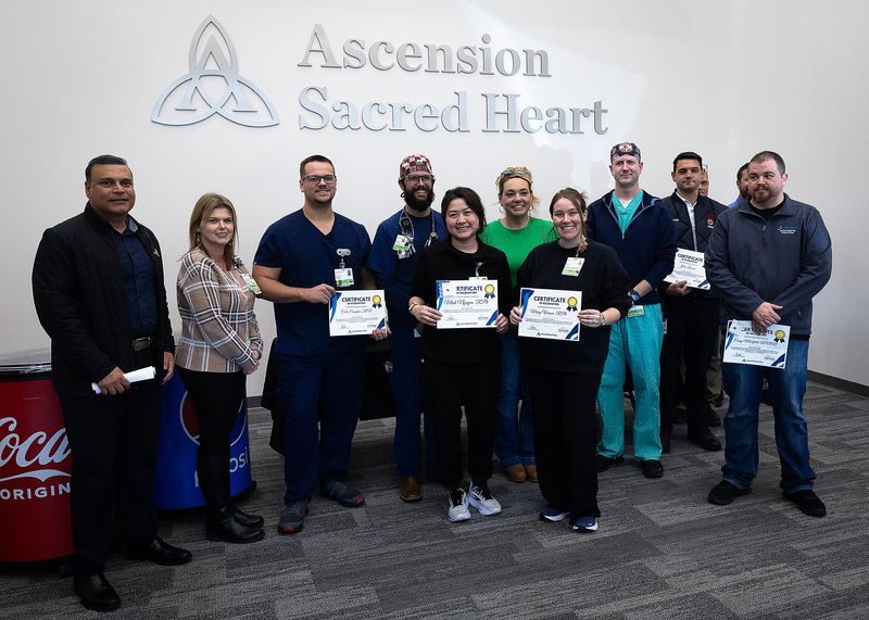 Health care workers are recognized at Ascension Sacred Heart Bay in Panama City, Fla., Dec. 8, 2025. The event recognized "Stroke Superheroes" and the one-year anniversary of the hospital's neurothrombectomy program. (Tyler Orsburn/News Herald)