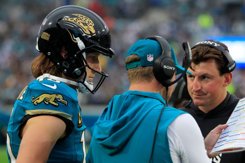 Jacksonville Jaguars quarterback Trevor Lawrence (16) looks on as head coach Liam Coen talks a play with offensive coordinator Grant Udinski looking on during the first quarter of an NFL football game at EverBank Stadium, Sunday, Dec. 7, 2025, in Jacksonville, Fla. The Jaguars defeated the Colts 36-19.