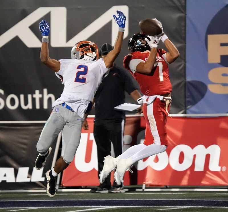 Mooney wide receiver Bo Odaniel (#7) pulls in a pass for a touchdown against Bolles defensive back Santana Starks (#2). The Cardinal Mooney Catholic High School Cougars met the Bolles High School Bulldogs for the FHSAA Class 2A state football championship Wednedsay evening, Dec. 10,2025 in Miami.