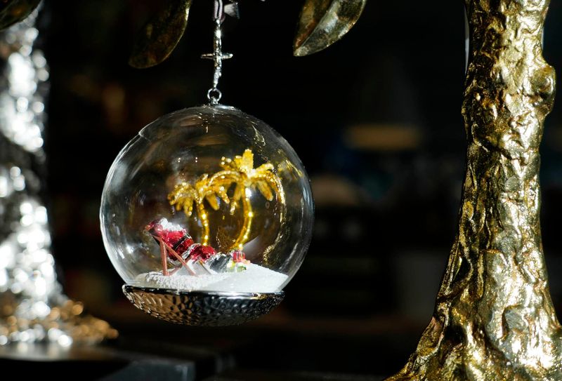 Main Street by The Breakers sells this snow-globe ornament with a lounging Santa and palm trees ($90) at 223 Royal Poinciana Way, Palm Beach.