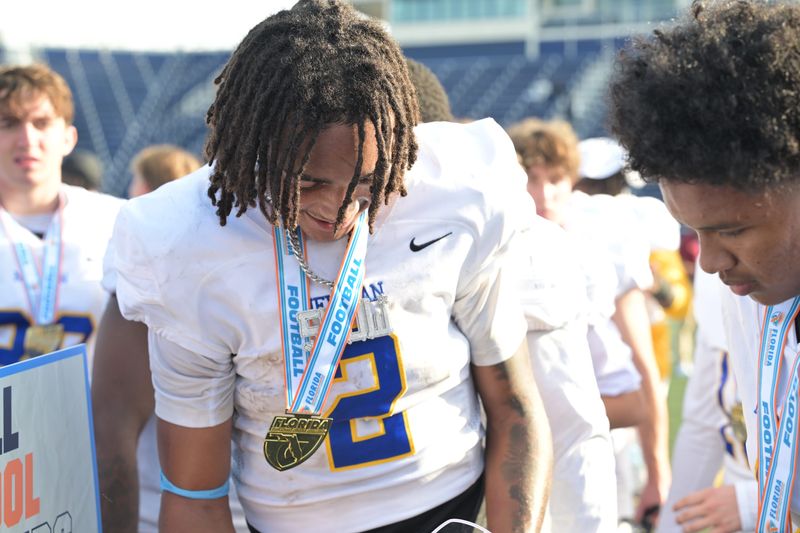 Cardinal Newman's Jyron Hughley wears a big smile as he receives MVP recognition following the team's Class 1A state championship win over Chaminade Madonna on Dec. 11, 2025.