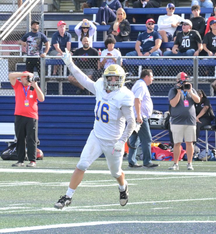 Cardinal Newman's Cooper Clark celebrates a big defensive play during the Crusaders' state championship victory over Chaminade Madonna on Dec. 11, 2025.