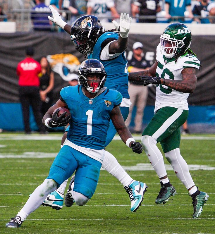 Jacksonville Jaguars running back Travis Etienne Jr. (1) run for a touchdown in the fourth quarter during an NFL football game at EverBank Stadium, Sunday, Dec. 14, 2025, in Jacksonville, Fla. The Jaguars defeated the Jets 48-20. [Doug Engle/Florida Times-Union]